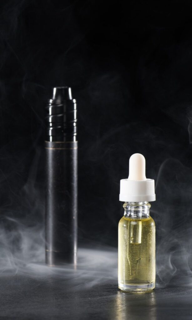 electronic cigarette and liquid with clouds of smoke on dark background e1626674164870 1